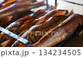 Grilling fresh fish for a delicious outdoor meal 134234505