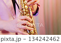 Extreme close-up of a soprano saxophone player's hands: Pink 134242462
