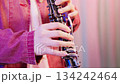 An extreme close-up of the hands of a person playing the clarinet. 134242464