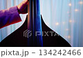 Super close-up of the hands of a person playing the double bass 8 134242466