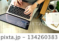 A slow-motion view shows a woman typing on a laptop on her knees, highlighting gentle motion, concentration, and a calm working mood. 134260383