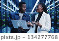 Modern business scene of IT professionals working together in a data center 134277768