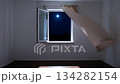 The wind from the window flutters the curtains in the old house in the moonlight. 134282154