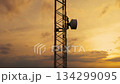 Aerial view during a scenic sunset of a telecommunication tower. Designed for transmitting cellular 134299095