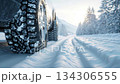 Winter Car Tires Driving on Snowy Road in Cold Weather 134306555
