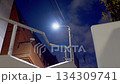Street lights at night and a man running down the stairs 134309741