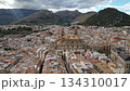 Enjoy a Scenic Aerial View of a Beautiful Historic City Surrounded by Majestic Mountains 134310017