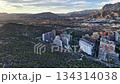 Aerial Mountain Residential Skyline At Sunrise Showing Planner Drone Inspecting Housing Clusters, Pine Forest, 134314038