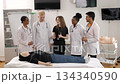 Diverse medical students listening to a teacher during a practical lesson 134340590