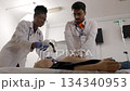 Medical students practicing CPR and breathing support on a dummy 134340953