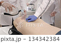 Medical students practicing emergency cpr on a dummy 134342384
