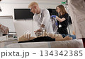 Medical students learning cpr techniques with a mannequin 134342385