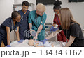 Diverse medical students learning infant CPR on a resuscitation dummy 134343162