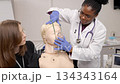 Medical students practicing intubation procedure on a training dummy 134343164