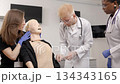 Medical students practicing catheterization on a patient simulator dummy 134343165