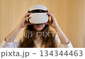 Woman Putting On and Using Virtual Reality Headset 134344463