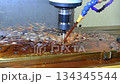 Slow motion scene the CNC milling machine rough cutting the mold parts with oil coolant method.  134345544