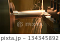 Close up scene the lathe machine finish cut metal shaft parts with liquid coolant method. 134345892