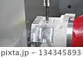 Slow motion scene 5-axis machining center cutting automotive parts with indexable tool.  134345893