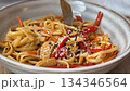 Asian noodle dish with chicken, red peppers, carrots, and sesame seeds in a ceramic bowl video Asian noodle dish with chicken, red peppers, carrots, and sesame seeds in a ceramic bowl video 134346564