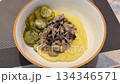 Bowl of creamy mashed potatoes with mushroom sauce and pickles as colorful background video Bowl of creamy mashed potatoes with mushroom sauce and pickles as colorful background video 134346571
