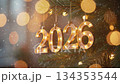 2026 New Year celebration ornament hanging on Christmas tree with lights and beautiful bokeh  134353544