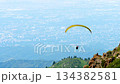 Paraglider flying over mountains 134382581