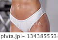 Close-up footage of a slim and fit female body wearing white underwear 134385553
