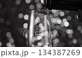 Pouring Champagne Wine on shine background. 134387269