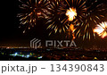 Bright, large fireworks explode across a deep black night sky above a city, with the camera moving to create an immersive, cinematic celebration scene 134390843
