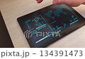 Person interacts with hightech touch screen, software responding by showing world map. Technology 134391473