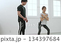 Young woman receiving training from a personal trainer Young woman receiving training from a personal trainer 134397684