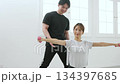 Young woman receiving training from a personal trainer Young woman receiving training from a personal trainer 134397685