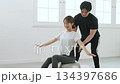Young woman receiving training from a personal trainer Young woman receiving training from a personal trainer 134397686