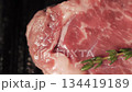 Top view on juicy rib eye steak with rosemary branch frying on a hot grill pan. Cooking delicious steak at home. High quality 4k footage 134419189