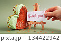 THANK YOU text thanksgiving day Delightful and vibrant heartshaped pastry croissant treat, beautifully topped with colorful frosting nut galore. Mock up template copy space. Food experimentation viral 134422942