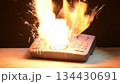 Desktop phone ignition with bright flames and flying sparks. Suitable for visualising the consequences of short circuits or overheating electronics. 134430691
