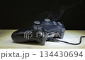 A game joystick fire with bright sparks is a concept of technological failure 134430694