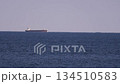 Ship A passing near the horizon offshore 134510583