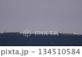 Ships passing by near the horizon offshore 134510584