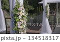 Floral arch decorated with flowers for outdoor ceremony. 134518317