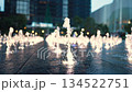 slow motion of illuminated stylish fountain jets in modern city at night, glowing water streams at urban plaza at dusk 4k 134522751