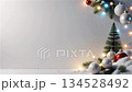 Christmas background with falling snow ornaments and festive lights on elegant gray backdrop with copy space 134528492