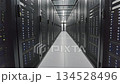 Modern data center server room corridor with illuminated server racks and LED status lights in clean white hallway 134528496