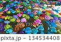 Rainbow palette floating toy fish set swirling softly across pool water creating relaxing ASMR friendly background footage 134534408