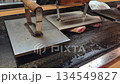 Teppanyaki cooking styke at okonomiyaki shop pork steak press with iron plate 134549827