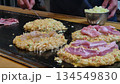 Hot freshly cook okonomiyaki Japanese style pizza on hot plate Osaka street food 4k 134549830