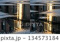 Rainy city scene with flooded fire escape and brick building reflections 134573184