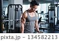 man lifting light dumbbells in slow controlled repetitions 134582213