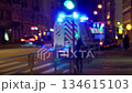 Urgent ambulance response beneath streetlights, Bluelight ambulance arriving amidst nighttime urban panic Urgent ambulance response beneath streetlights, Bluelight ambulance arriving amidst nighttime urban panic 134615103